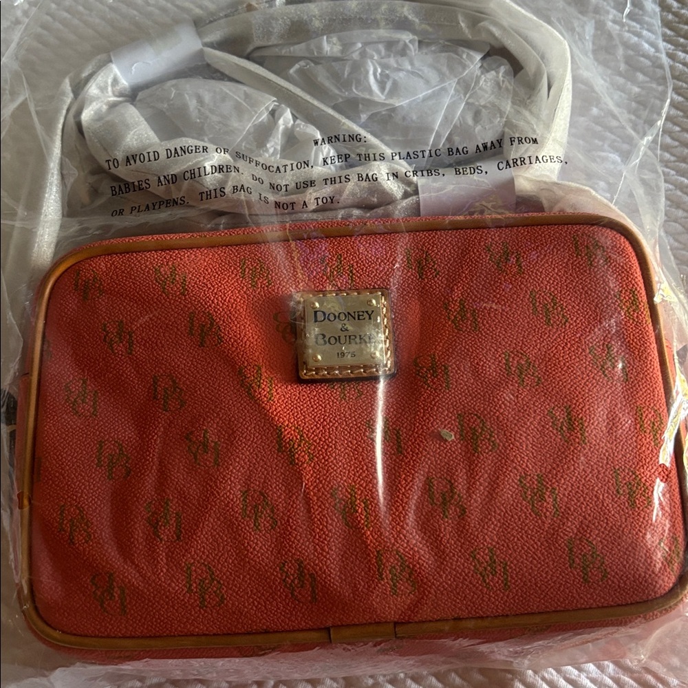 Dooney & Bourke Loni Signature Logo Crossbody Bag in Coral/tan leather NWT.
